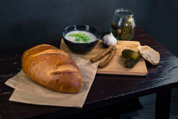 Fresh bread with lard and pickled cucumbers