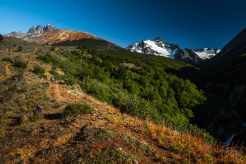Ice caped Chilean mountains. Little hiker is barely visible on the left pat of the frame