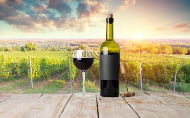 Red wine with barrel on vineyard in green Tuscany, Italy