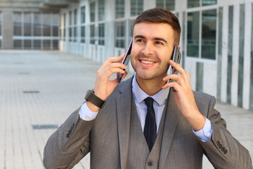 Businessman using two phones simultaneously 