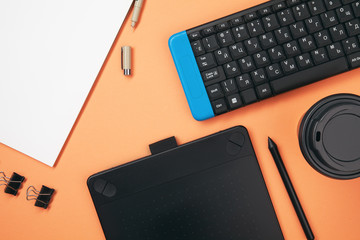 Top view on desktop isolated on trending coral background. Top view on retoucher workspace....