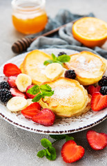 Delicious pancakes with berries on a concrete backrgound