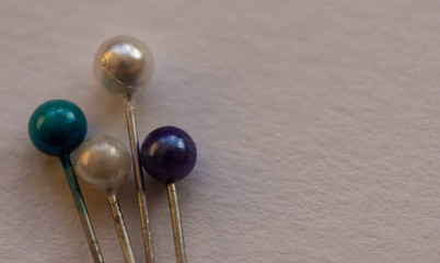 Dressmaker fabric pins on a white background with room for text