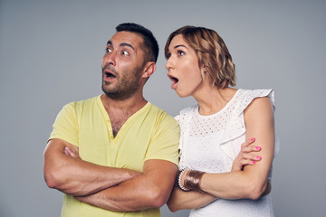 Young couple looking aside at copy space smiling