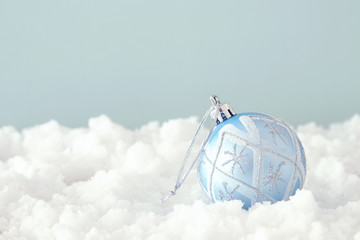 Image of christmas festive tree blue ball decoration in front of pastel background background.