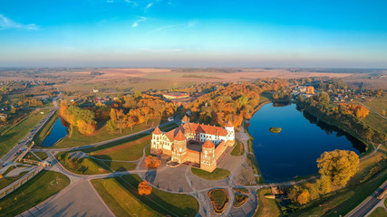 Mir castle in the sunsetlight. Drone aerial panorama