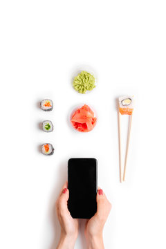 Japanese Restaurant Online Order And Delivery Sushi Rolls Chopsticks Hands Holding Top Phone Mockup White Background