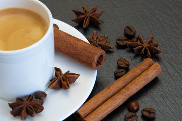 Coffee set. Espresso drink in white cup with cinnamon quills and star anise