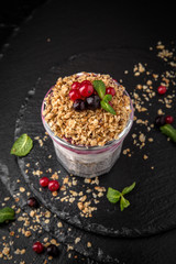 Сhia pudding or yogurt with granola, raspberries, black and red currants and blueberries.  Healthy breakfast concept and idea. Detox and healthy superfoods.