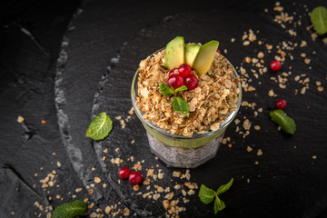 Сhia pudding or yogurt with granola,  avocado and berries.  Healthy breakfast concept and idea. Detox and healthy superfoods.