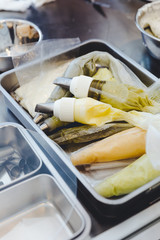 Many pastry bags with colored cream inside for making decorated flower for cake.