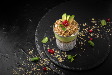 Сhia pudding or yogurt with granola,  avocado and berries.  Healthy breakfast concept and idea. Detox and healthy superfoods.