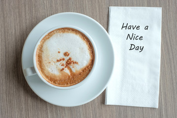 HAVE A NICE DAY word with hot cappuccino coffee cup on table background at the morning. New Year New Start, Resolution, Solution, Strategy and Mission concept