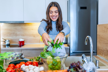 The woman in the process of making vegetable salad. Healthy Eating. Diet Concept. A Healthy Way Of Life. Cook At Home. To Prepare The Food. Girl mixing salad .