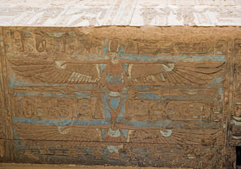 Painted hieroglyphic carvings on an ancient egyptian temple wall