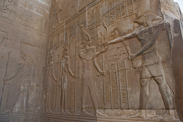 Hieroglyphic carvings on an ancient egyptian temple wall