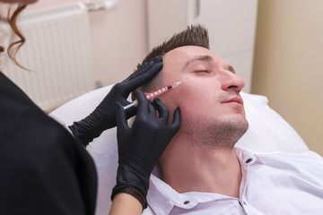 Portrait of a men, having a face mesotherapy on beauty clinic.