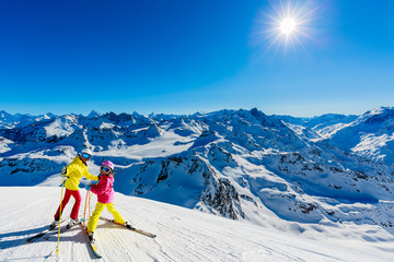 Happy family enjoying winter vacations in mountains . Ski, Sun, Snow and fun.