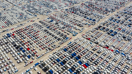 Cars export terminal in export and import business and logistics. Shipping cargo to harbor. Water transport International. Aerial view and top view.