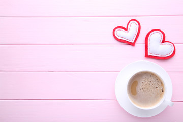 Valentine's day background. Cups of coffee with hearts on pink table