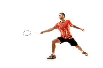 Fototapeta na wymiar Young man playing badminton over white studio background. Fit male athlete isolated on white. badminton player in action, motion, movement. attack and defense concept