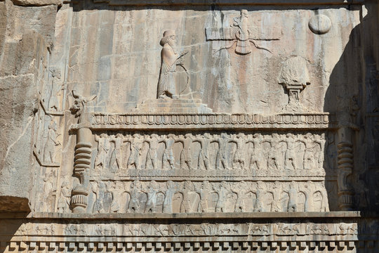 The beautiful reliefs on the Tomb of Artaxerxes in the ruins of Ancient Persepolis Complex of Near Eastern civilisation with persian architecture, Pars - Iran