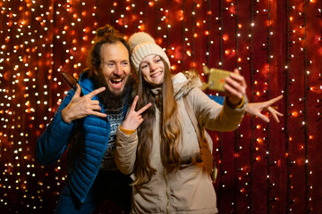 Father and daughter taking selfie at Christmas market.