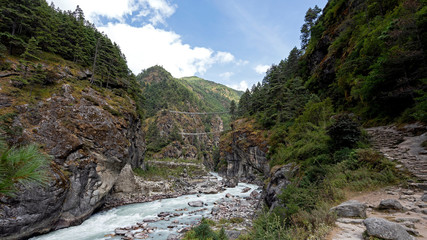 Suspension bridges over a river along the path towards Namche town of Khumbu region.