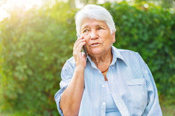 old woman talking on the phone, smartphone, smiling, call children