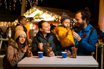 Family enjoying traditional food at Christmas market in Zagreb, Croatia. - 238186871
