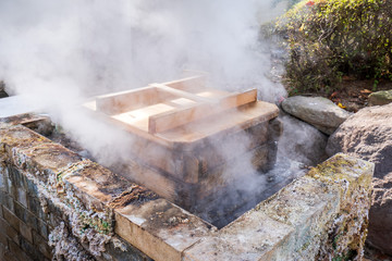 Hot pot steamer near UMI JIGOKU (Sea Hell) pond in autumn, which is one of the famous natural hot springs viewpoint, the japanese in picture means "It's high temper and danger, please don't touch."