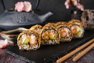 Hot fried Sushi Roll with shrimp, cucumber and unagi sauce. Sushi menu. Japanese food. 