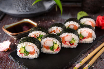 Futomaki with salmon, royal prawn, avocado, chuka, tobacca and cream cheese Philadelphia Sushi menu. Japanese food. 