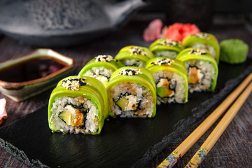 Vegetarian sushi rolls avocado with cream Philadelphia cheese, sesame, unagi sauce. Sushi menu. Japanese food. 