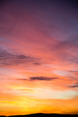 Dramatic sky with big clouds in the sunset. The sun is beautifully breaking through the clouds. Vertical