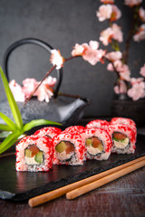 Japanese California Roll with salmon, avocado, cucumber, cream with Philadelphia cheese, tobiko caviar Sushi menu. Japanese food. 