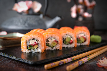 Philadelphia roll sushi with salmon, cucumber, avocado, cream cheese, tobiko caviar. Sushi menu. Japanese food. 