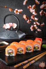 Philadelphia roll sushi with salmon, cucumber, avocado, cream cheese, tobiko caviar. Sushi menu. Japanese food. 