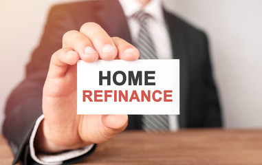 Businessman holding a card with text Home refinance