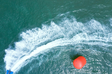 Aerial view of red U-turn point for playing a jet ski in the sea which top view of  the water and...