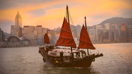 Beautiful view in the morning with Chinese Junk ship operating in Victoria Harbour, Hong Kong.