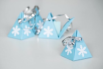 Close up Christmas blue pyramid gift box, present, handmade fold cardboard paper, decorated with...