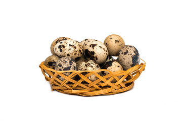 Obraz premium Quail eggs in wicker basket on white background