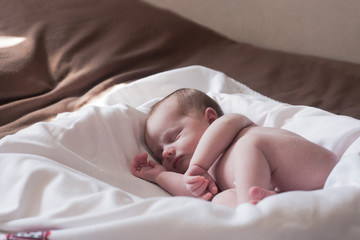 Newborn Baby girl sleeping in bed