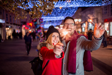 Fototapeta premium Having fun in the winter city street on Christmas eve.