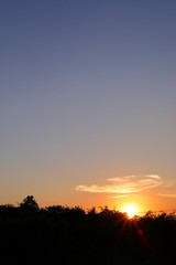 Fototapeta premium orange sun light on beautiful sunset clear blue sky background