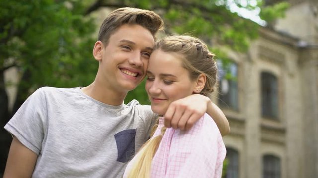 Couple of teens making selfie, first kiss, feelings of embarrassment, pure love