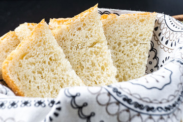 Fresh homemade baked bread and sliced bread on rustic white wooden table