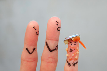 Fingers art of family during quarrel. Concept of parents scold the child because he put a plate of food on his head.
