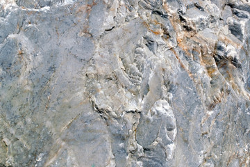 texture of stone on the seashore close-up. gray background of marble stone.